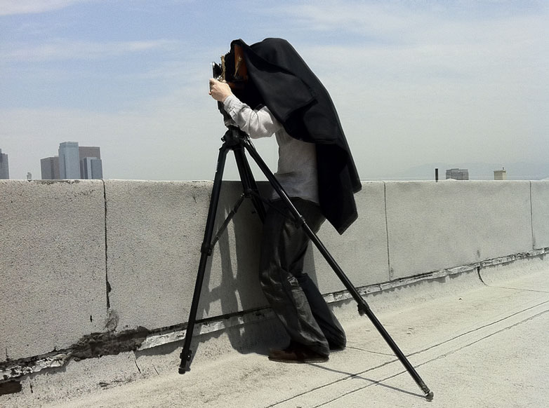 Peter Beard with a large format camera on the roof of American Apparel, Los Angeles, 2011.